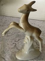 Front view of ceramic leaping gazelle figurine