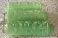 Three green embossed cylindrical glass shades side view