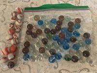 Both bags of marbles, showing colors and quantities