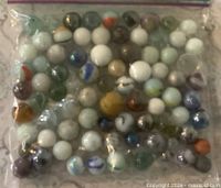 Bag containing assorted lustre glass marbles
