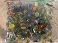 Front view of full zip-top bag showing quantity and variety of marbles