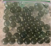 Full view of zip-lock bag containing marbles