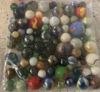 sealed plastic bag filled with assorted marbles of varying sizes