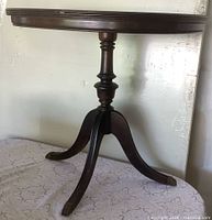 Full view of half-moon table showing top and tripod base