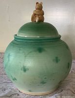 Front view of green ceramic lidded pot
