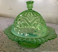 Complete butter dish assembled showing scalloped plate and ornate lid