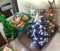 Full lot showing three tabletop trees and basket of craft supplies