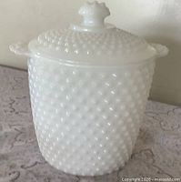 Front view of hobnail milk glass cookie jar with lid