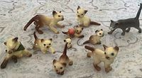 Group shot of all nine porcelain cat figurines