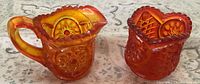 Front view of Amberina miniature creamer and sugar bowl showing color gradient and Moon and Stars pattern