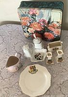 Entire lot group shot showing biscuit tin and all china pieces