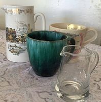 Group shot of pitcher, two mugs and glass creamer