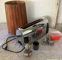 Group shot of all items: Krups toaster, wooden planter, Pyrex dish, silver cup, cruet set, tall shaker