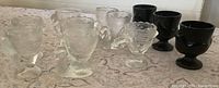 Group of clear and black bird egg cups on table