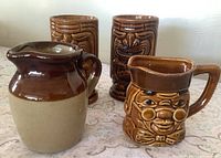 Front view of all four pieces showing designs and glaze