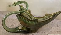 Side profile showing full swan form and color swirls