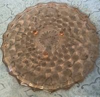 Top view of pink depression glass footed cake plate