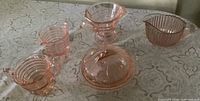 Overall view of all five pink Depression glass pieces