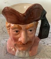 Front view of ceramic pirate head pitcher showing facial details and tricorn hat