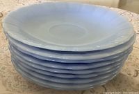 Stack of nine Delphite Blue saucers