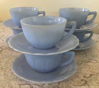 Stacked view of six teacup and saucer sets