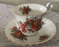 Teacup on saucer showing pattern and gold trim