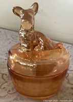 Front view of Jeanette marigold carnival glass powder dish with Scottie dog lid