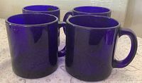 front view of four cobalt blue mugs