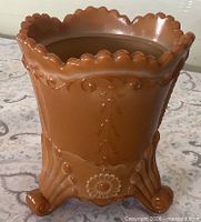 Front view of brown caramel slag glass vase showing scalloped rim and front decoration