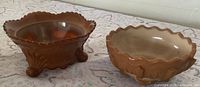 Oblique view of both slag glass bowls showing color, rims, and footed design