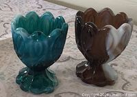 Front view of both slag glass egg cups showing colors and Moon and Stars pattern