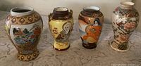 Front view of all four Satsuma vases