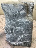 Front view of grey soapstone Inuit sculpture