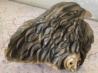 Front view showing eagle head and carved feather detail