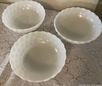 Top view of three identical white milk glass Bubble pattern bowls