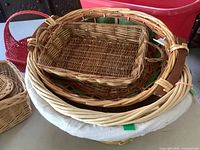 Stack showing multiple baskets including large round tray, rectangular tray, hamper, red basket