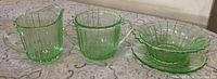 Front view of sugar bowl, creamer, cereal bowl stacked on saucer