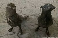 Front view of both pewter pheasant shakers