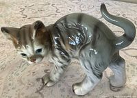 left side view of gray tabby cat figurine