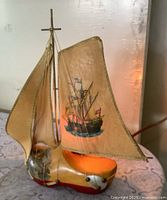 Front view showing painted clog base, printed sail shade, bulb glow
