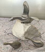 Large Hoselton bird on stone base with two small birds