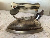 Left side view of Westinghouse iron showing marbled handle, temperature gauge, chrome body