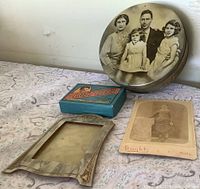 Group shot of frame, tin, card game box and cabinet card