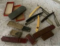 Overall view of razors, stone and cases on patterned surface