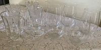 Group of 5 stemless wine glasses and 4 Irish coffee mugs on table