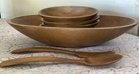 All pieces side view showing nesting bowls, fork, spoon