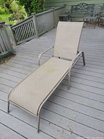Single metal frame chaise lounge on deck showing full length and adjustable backrest
