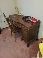 Desk with chair against wall showing overall form and finish