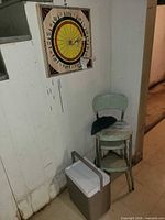 Cooler, dartboard, folding chair grouped together