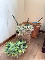 Two seagrass baskets, metal planter, faux greenery